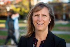 Polly Smith smiles at camera on campus at Utica College.